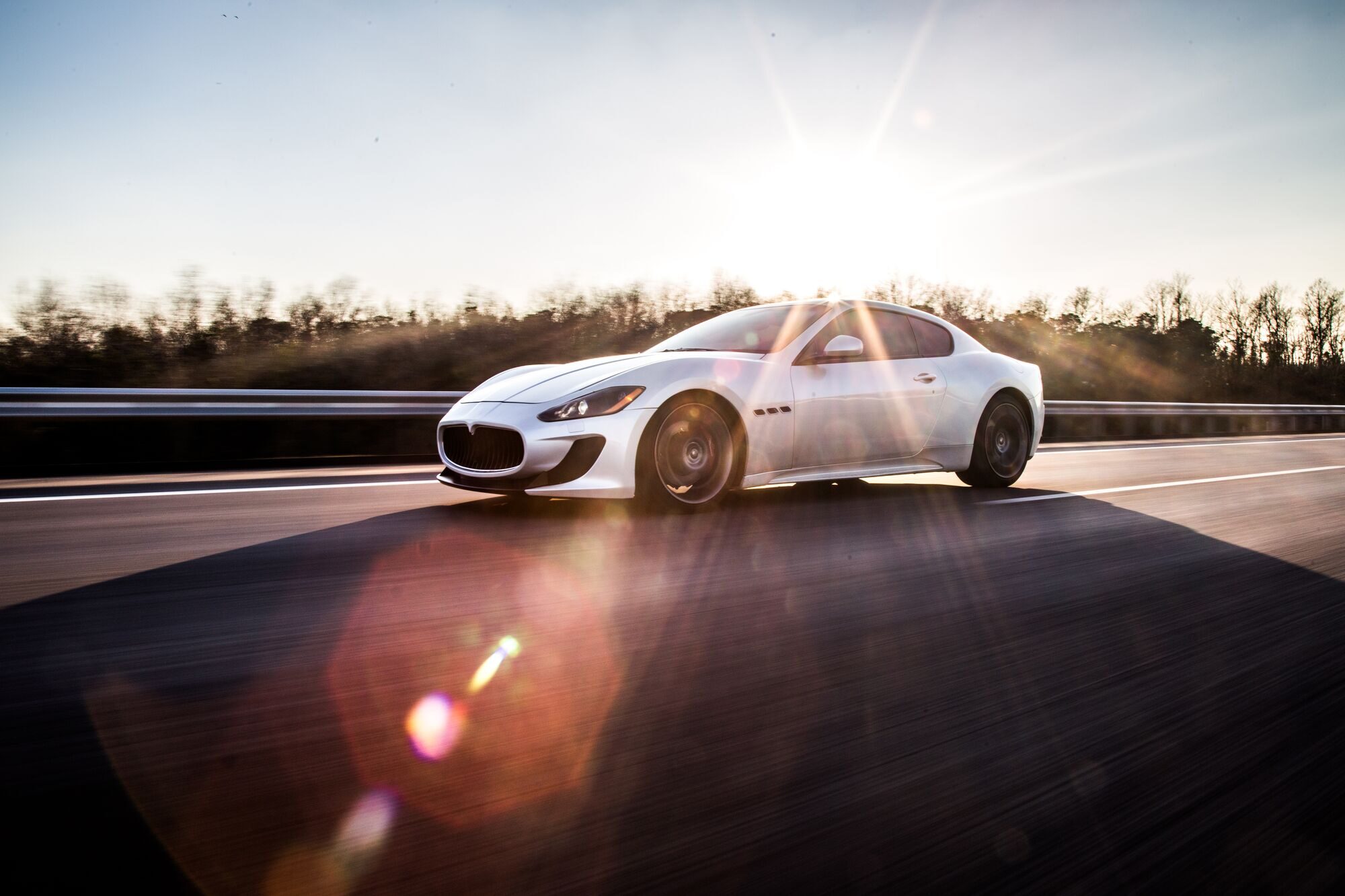 high-speed-silver-sport-car-driving-highway-sunny-weather